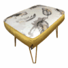 Luxurious beige pouffe with floral pattern and gold accents, perfect for stylish living rooms.