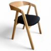 Scandinavian oak dining chair with ergonomic bentwood backrest.