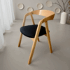 Scandinavian oak dining chair with ergonomic bentwood backrest.