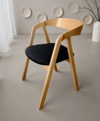 Scandinavian oak dining chair with ergonomic bentwood backrest.