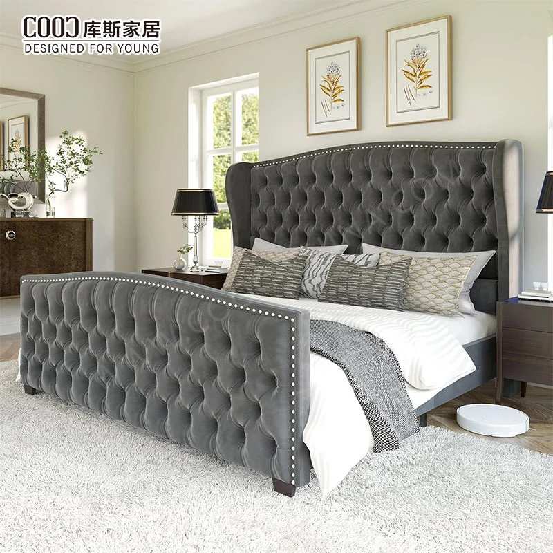 Modern bedroom with a luxurious tufted velvet upholstered bed frame featuring a high wingback headboard and matching footboard