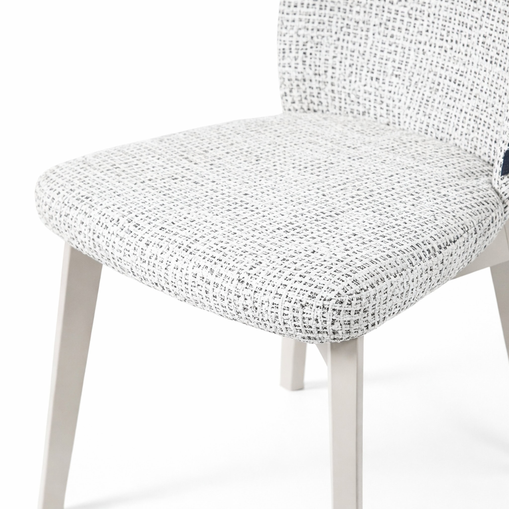 Soft textured white pouffe chair with wooden legs, perfect for modern living spaces.