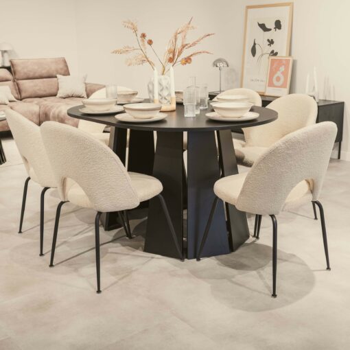 Sterling Extendable Round Dining Table in black with beige upholstered chairs, set for dining, showcasing a modern interior design aesthetic.