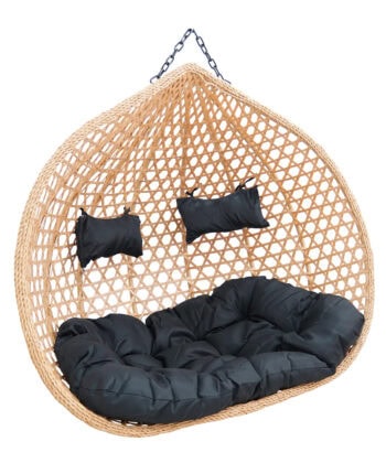 Egg-shaped hanging rattan chair with black cushions and pillows, perfect for outdoor or indoor relax.