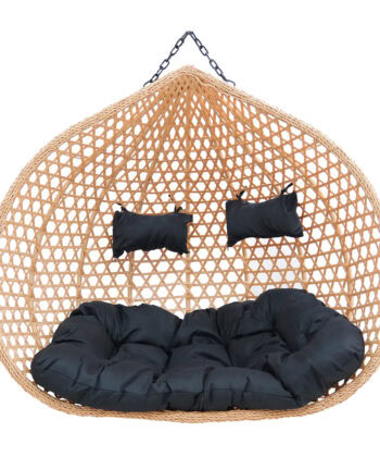 Relaxing hanging wicker pod with black cushions, perfect for outdoor lounging and stylish home decor.