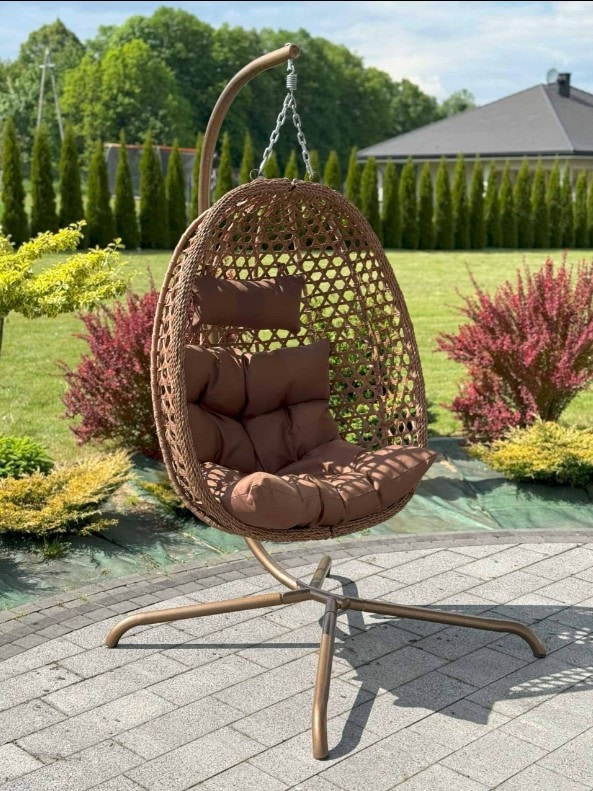 Comfortable outdoor hanging egg chair with plush cushions, perfect for relaxing in garden or patio s.