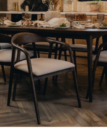 Elegant dining room with dark wood table and upholstered chairs, perfect for family gatherings and d.
