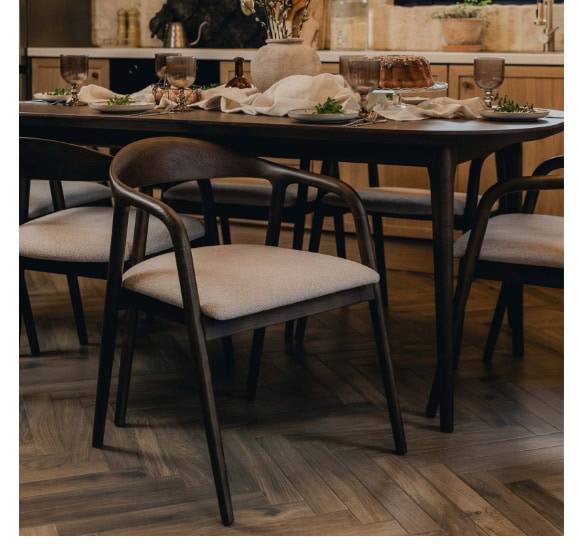 Elegant dining room with dark wood table and upholstered chairs, perfect for family gatherings and d.