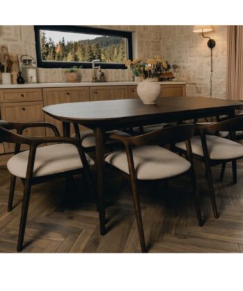 Elegant dining room with wooden table and six upholstered chairs, natural light, and scenic outdoor.