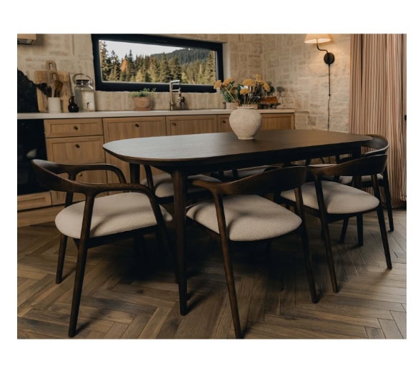 Elegant dining room with wooden table and six upholstered chairs, natural light, and scenic outdoor.