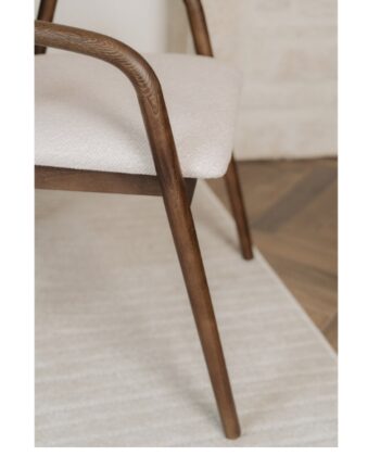 Elegant wooden chair with cream upholstery, modern design, and natural finish. Perfect for contempor.