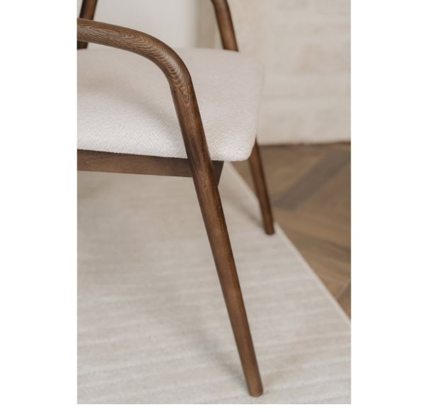 Elegant wooden chair with cream upholstery, modern design, and natural finish. Perfect for contempor.