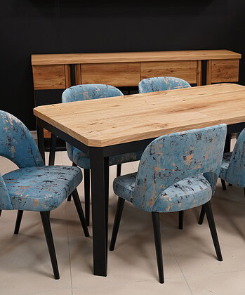 Modern wooden dining table with six upholstered blue chairs in a contemporary setting.