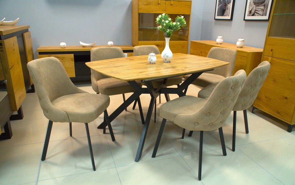 Elegant wooden dining table with beige upholstered chairs in a modern interior setting.