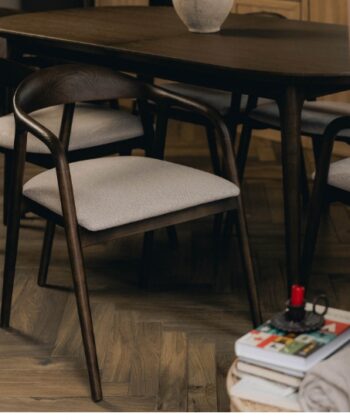 Modern dining room with dark wood table and stylish chairs, cosy and elegant setting.