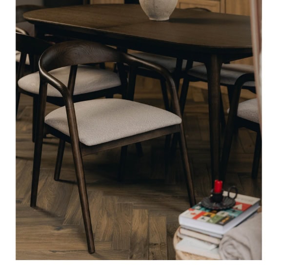 Modern dining room with dark wood table and stylish chairs, cosy and elegant setting.