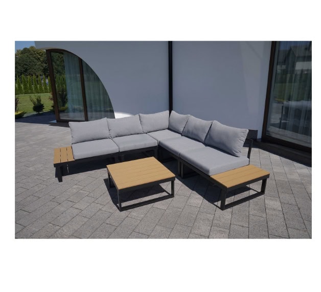 Modern outdoor sectional sofa with grey cushions and wooden tables on patio.