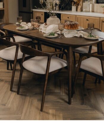 Modern wooden dining table with six upholstered chairs in a contemporary kitchen setting.