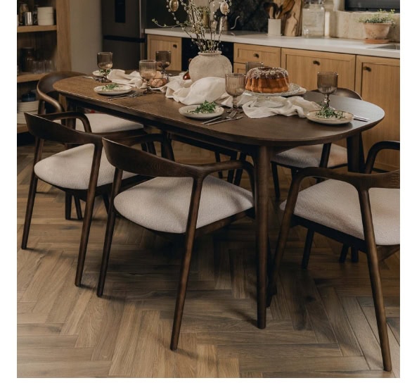 Modern wooden dining table with six upholstered chairs in a contemporary kitchen setting.