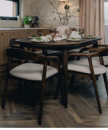 Modern wooden dining table with six upholstered chairs in a stylish kitchen setting.