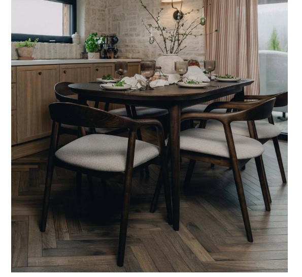 Modern wooden dining table with six upholstered chairs in a stylish kitchen setting.