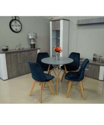 Modern dining room with grey furniture and navy blue chairs, stylish decor, and a round table.