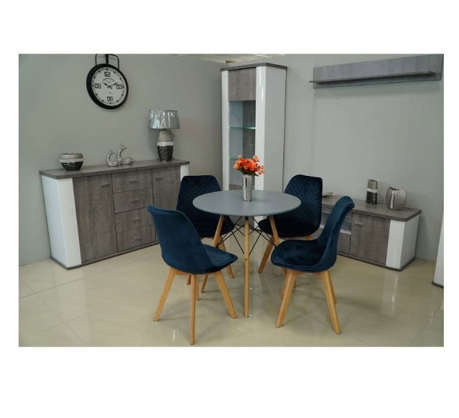 Modern dining room with grey furniture and navy blue chairs, stylish decor, and a round table.
